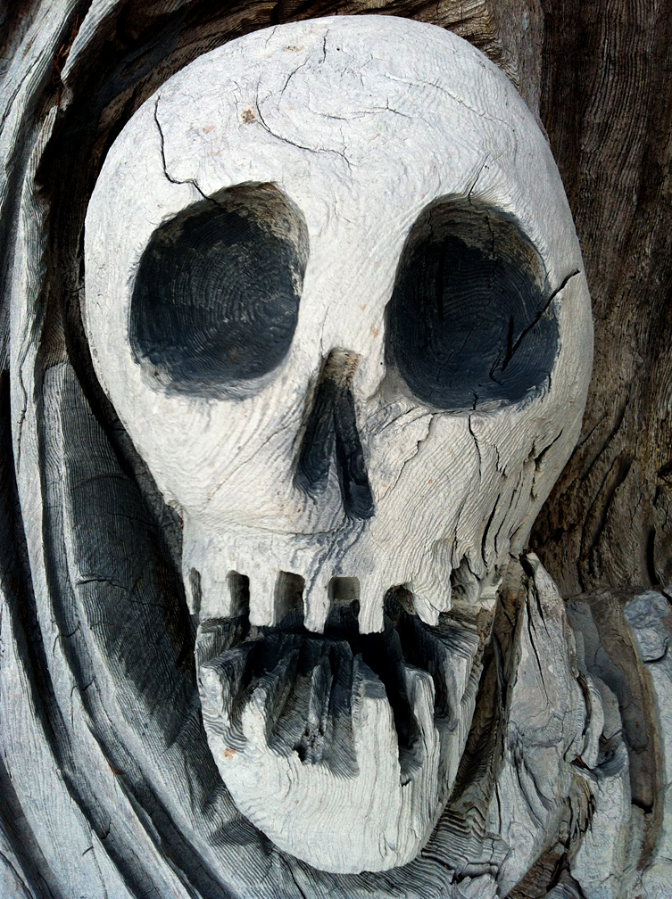 life-size skull carving in wood